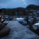 A Puerto Rican who still relies on generators for power checks her phone on her rooftop at dusk on October 5, 2017 in San Isidro, Puerto Rico. (Photo by Mario Tama/Getty Images)